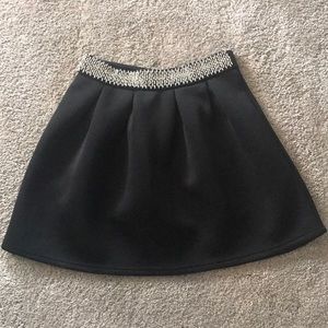 Francesca’s black pleated skirt